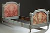 French Carved Polychromed Beech Louis XVI Style Bed, early 20th c., the arched headboard over an upholstered cushioned panel flanked by turned tapered
