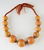 Moroccan Berber Amber Resin Necklace, 20th c., with eleven large graduated beads, with metal spacers, on a twisted wool cord, L.- 18 in.
