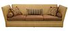 Edward Ferrell Sofa, having Knole drop ends with tassels, upholstered in tan ostrich skin with brown upholstered cushions, height 46 inches, length 12
