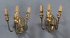 Pair of Brass and Giltwood Three Light Wall Sconces, c. 1920, the oval back plate issuing three curved arms with carved gilt wooden candle cups and fa