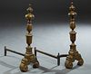Pair of Large Continental Brass Andirons, 20th c., with acorn finial tops on knopped supports, to a large reeded urn support, on a scrolled trestle ba