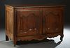 French Provincial Louis XV Style Carved Walnut Sideboard, 19th c., the stepped rounded corner three board top over double arched panel cupboard doors 