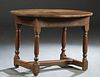 French Provincial Louis XIV Style Carved Oak Oval Side Table, early 19th c., the three board top over a frieze drawer, on turned and block legs, joine