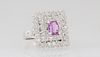 Lady's 18K White Gold Dinner Ring, with a central 1.08 ct. oval pink sapphire atop double concentric graduated squares of round diamonds, the shoulder