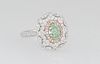 Lady's 18K White Gold Dinner Ring, with an oval 1.06 ct. green diamond, atop a border of pink diamonds, and an outer pierced scalloped border of round