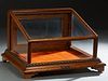 Carved Oak Table Top Display Case, c. 1900, by the J. W. Winchester Co., Ojai, California, the slanted glazed top over three glazed sides and a rear h