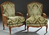 Pair of French Louis XV Style Carved Beech Fauteuils, 20th c., the arched floral carved crest rail to an upholstered back, over upholstered double can