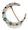 A 9 CARAT WHITE AND YELLOW GOLD EMERALD AND DIAMOND CRESCEN