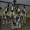 Early to Mid 20th Century Iron, Gilt Tole and Crystal Twelve Light Chandelier.