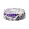 A chevron amethyst paperweight. Of oval form with facetted upper edge, various white-edge inclusions