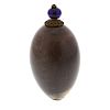 A hardstone scent bottle. The ovoid body with brown and beige hue, glowing violet under light, 48mm