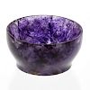 A small Blue John bowl.  Of footed hemispherical form with lilac and violet marbling, 45mm diameter