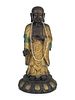 A Chinese Parcel-Gilt and Patinated Bronze FigureHeight 25 1/2 x width 5 1/2 inches.