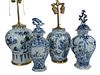 Group of Four Blue and White Delft Pieces to include a vase with foliate panel design, a vase with Oriental garden landscape with figures, repaired, 1