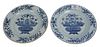Set of Eight Blue and White Plates having painted central floral basket, 19th century, diameter 9 inches.