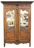 Louis XV Oak Armoire, top with 3D carved basket of flowers under molding and two carved panels and glass doors, 18th century, height 95 inches with re