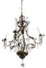 French Rococo Chandelier having four iron arms with metal leaf and crystal prism. Provenance: The Estate of Gloria Schiff, 630 Park Avenue, New York.