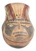 Pre-Columbian Pottery, portrait pot or vessel depicting polychrome head with face and headdress, height 10 1/2 inches, diameter 7 inches.