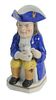Staffordshire Ralph Wood Toby Jug, seated having blue hat and jacket holding a pitcher, height 8 1/4 inches.