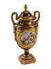 A Gilt Bronze Mounted Sevres Style Porcelain Urn and Cover
Height 17 x width 8 1/2 inches.