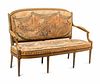 A Louis XVI Painted and Parcel Gilt Settee