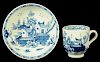 A LOWESTOFT COFFEE CUP AND SAUCER, C1790 painted in underglaze blue with a Chinese river scene,