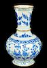 A CHINESE BLUE AND WHITE VASE, KANGXI  with lobed body and flared neck, painted with flowers, the