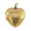 An early 20th century gold heart locket. The scroll engraved front panel, opening to reveal a photog