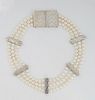 Mignon Faget Sterling Silver Necklace, with three strands of 7mm pearls and five indented rectangular spacers, with a large indented decorated sterlin