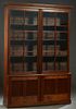 Large American Carved Mahogany Bookcase Cupboard, 19th c., the ogee crown over two mullioned six panel glazed doors, above two lower cupboard doors, o