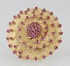Vintage 18K Yellow Gold Circular Brooch, the center dome mounted with a central round ruby atop double concentric graduated rows of small round rubies