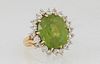 Lady's Vintage 18K Yellow Gold inner Ring, with an app 8 ct. oval peridot atop a border of ten ten point diamonds separated by an outer border of ten 