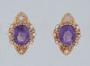 Pair of 18K Yellow Gold Pierced Earrings, each with an oval 4.5 ct. amethyst within a shaped pierced border mounted with eight five point round diamon
