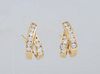 Pair of 18K Yellow Gold Pierced Earrings, with looped crossed bands , each earring with ten bezel set round ten point diamonds, with Omega clasps, tot