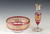 Two Pieces of Val St. Lambert Cranberry-to-Clear Cut Crystal, consisting of a gilt decorated baluster vase and center bowl, both with gilt bands of cl
