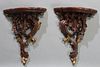 Pair of Carved Mahogany Bracket Shelves, 20th/21st c., the serpentine top on a pierce carved leaf and acorn support with gilt highlights, H.- 17 in., 