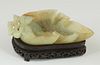 Chinese Carved Jade Leaf Form Brush Wipe, early 20th c., on a custom carved mahogany stand, H.- 1 1/4 in., W.- 5 3/4 in., D.- 3 7/8 in.
