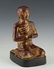 Polychromed and Giltwood Seated Buddha at Prayer, late 19th c., on an integral ebonized base, retaining much of the original gilt, H.- 11 3/4 in., W.-