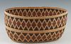 Southwestern Native American Open Oval Basket, 20th c., possibly Apache, with a tri-color diamond banded design, woven with dried willow and cottonwoo