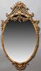 Large Impressive Louis XV Style Oval Gilt and Gesso Overmantel Mirror, 19th c., the arched latticed leaf, shell and scroll carved crest over floral ga