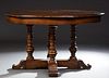 Unusual Carved Oak Circular Expandable Robert Jupe Style Dining Table, 20th c., by DeWitt Designs, the rounded edge circular top with fold out leaves,