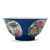 A CHINESE BLUE-GROUND FAMILLE ROSE FLOWERS BOWL