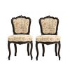 Par de sillas. SXX. Elaboradas en madera tallada. Con respaldos, asientos en tapicería de tela con motivos florales.