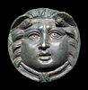A Roman Bronze Roundel with Head of a Gorgon
Diameter 2 7/10 inches.
