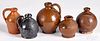 Four small redware jugs and a bank, 19th c.