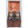 A Tantalus with Four Decanters and Glass