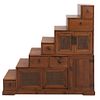 Cómoda. SXX. Diseño a manera de escalera. En madera entintada. A 2 cuerpos. Con 5 puertas y 6 cajones con tiradores. 130 x 132 x 39 cm