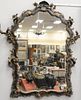 Venetian Black and Gilt Mirror, having three dimensional carving, 19th century, height 50 inches, width 36 inches.