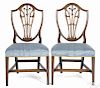 Pair of George III carved mahogany shieldback dining chairs, ca. 1785.