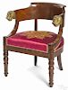French Empire mahogany low back armchair with ormolu lion's head handholds.